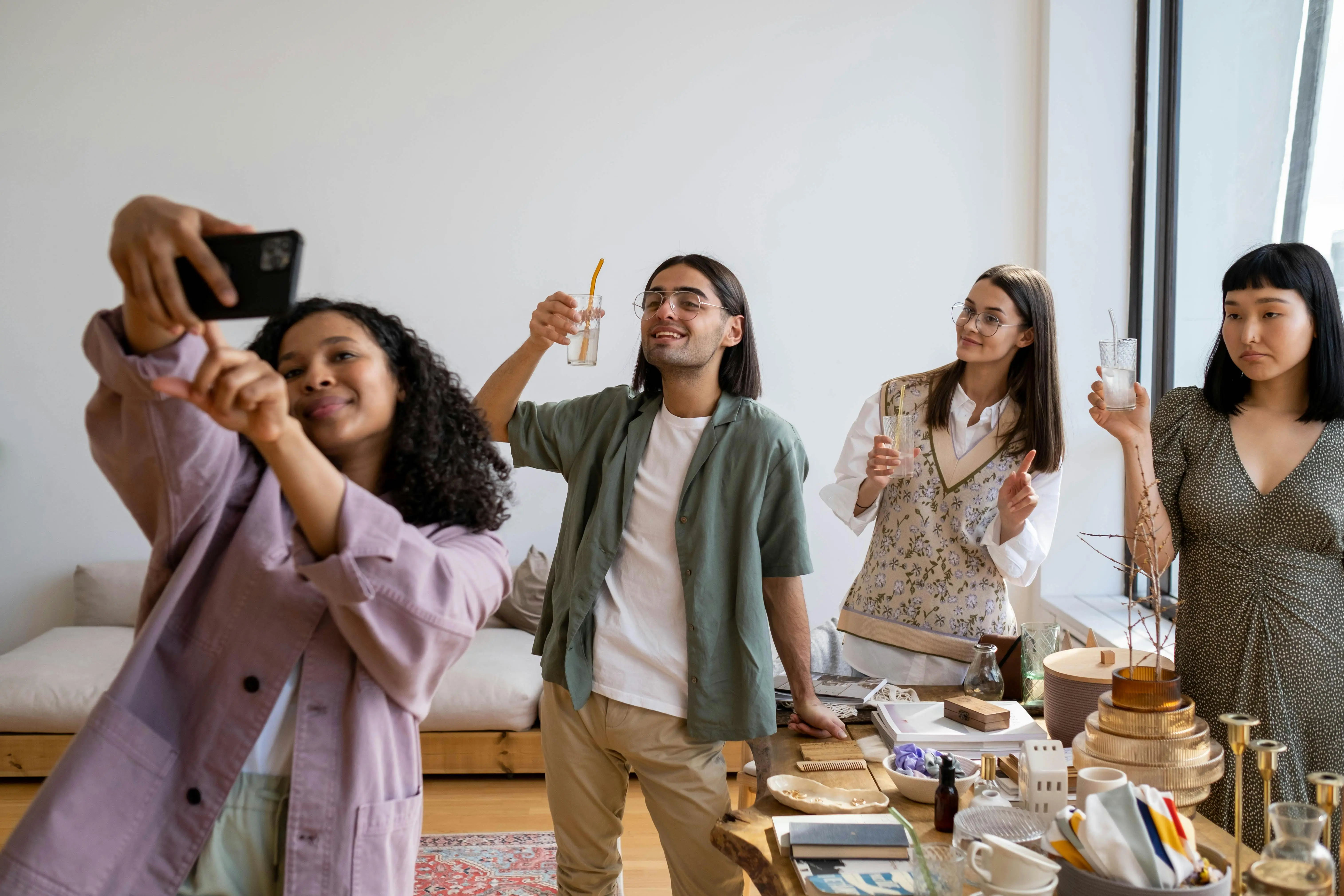 Group of friends taking a selfie and enjoying drinks at a holiday gathering, highlighting the importance of keeping a Scarborough home clean and welcoming for guests.