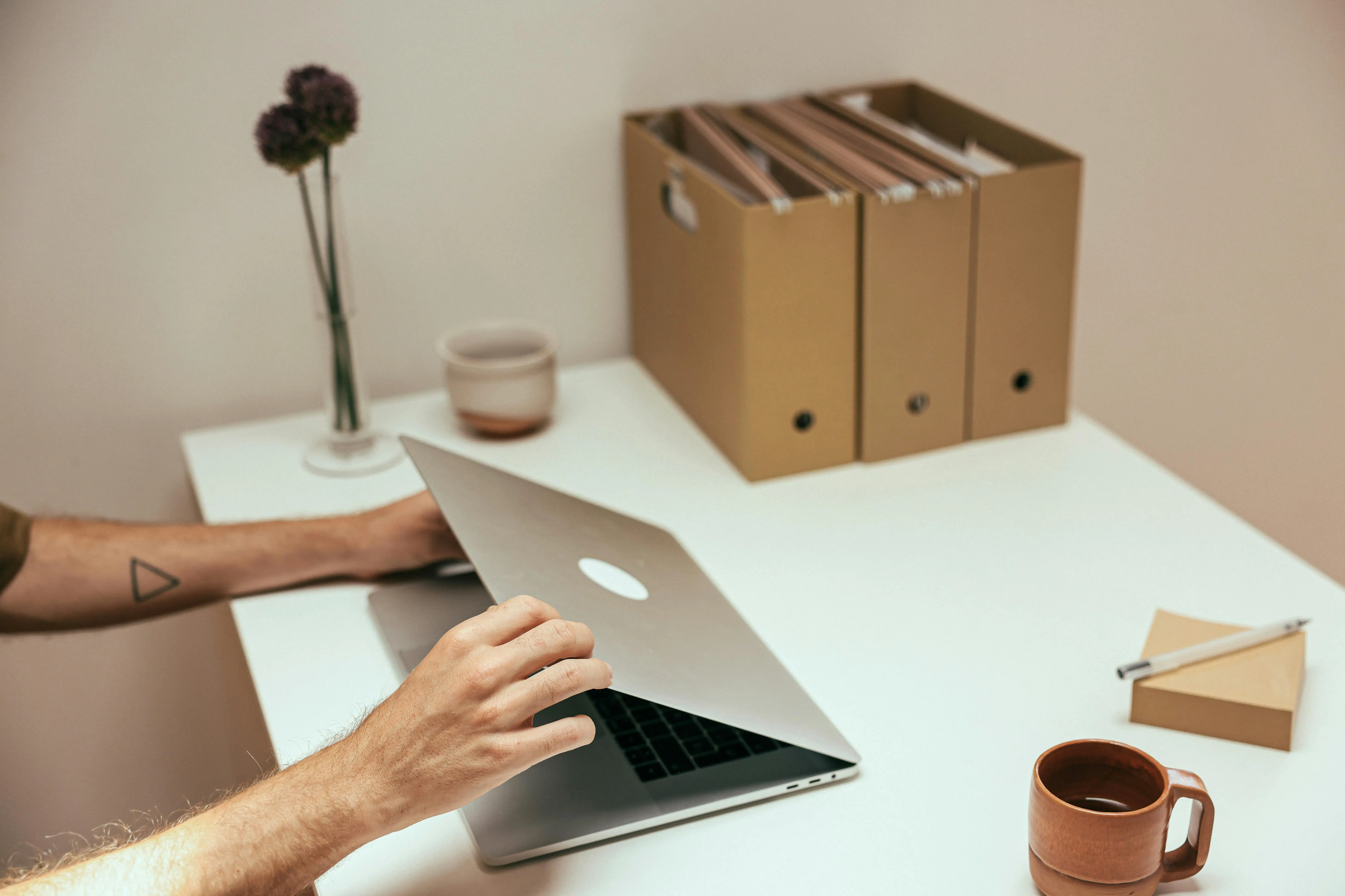 Decluttered home office desk with organized folders and laptop — affordable cleaning strategy for GTA families to save time and money.
