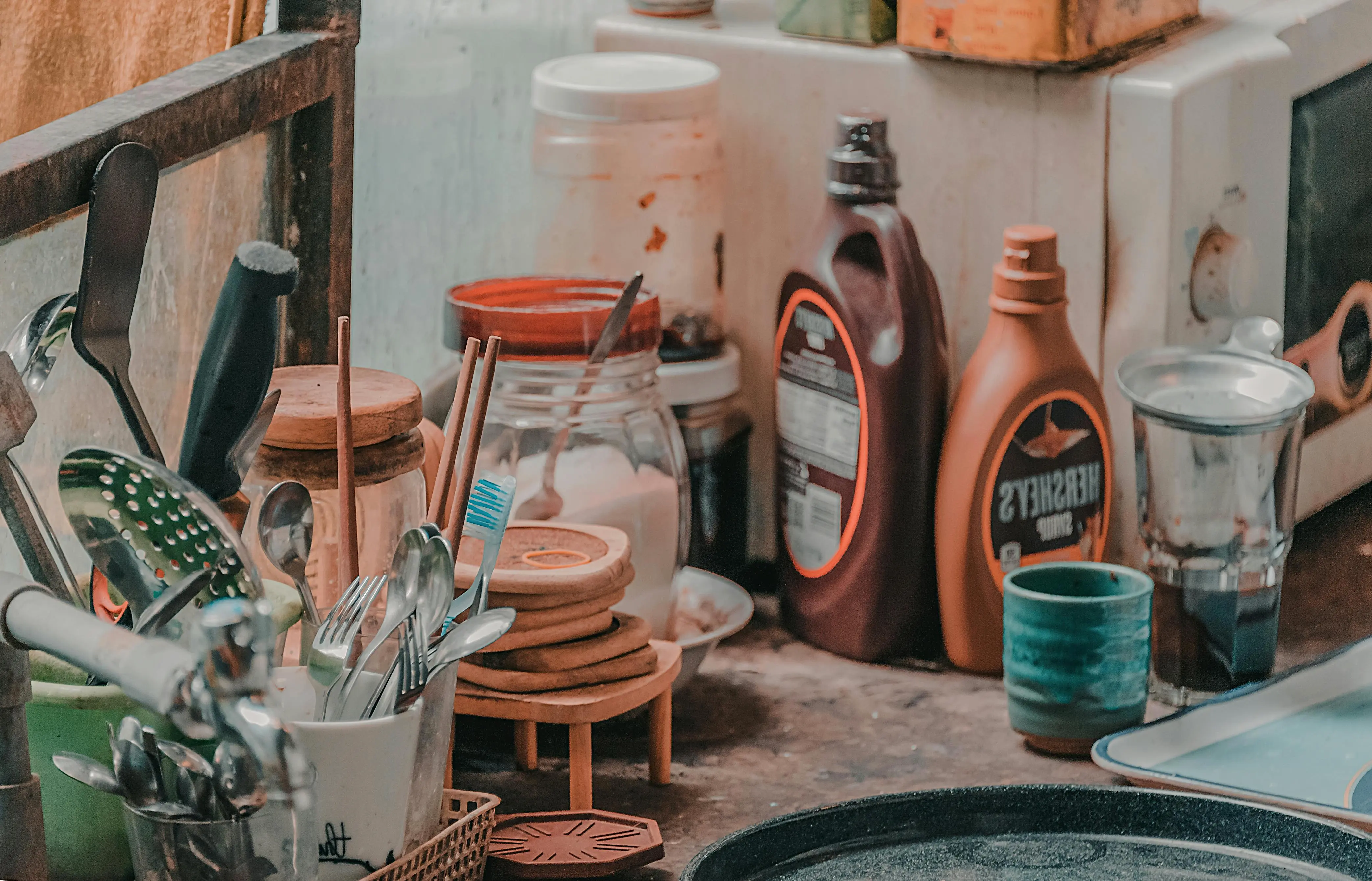 Cluttered kitchen counter with dishes and bottles illustrating how mess and disorganization increase stress in Richmond Hill homes.