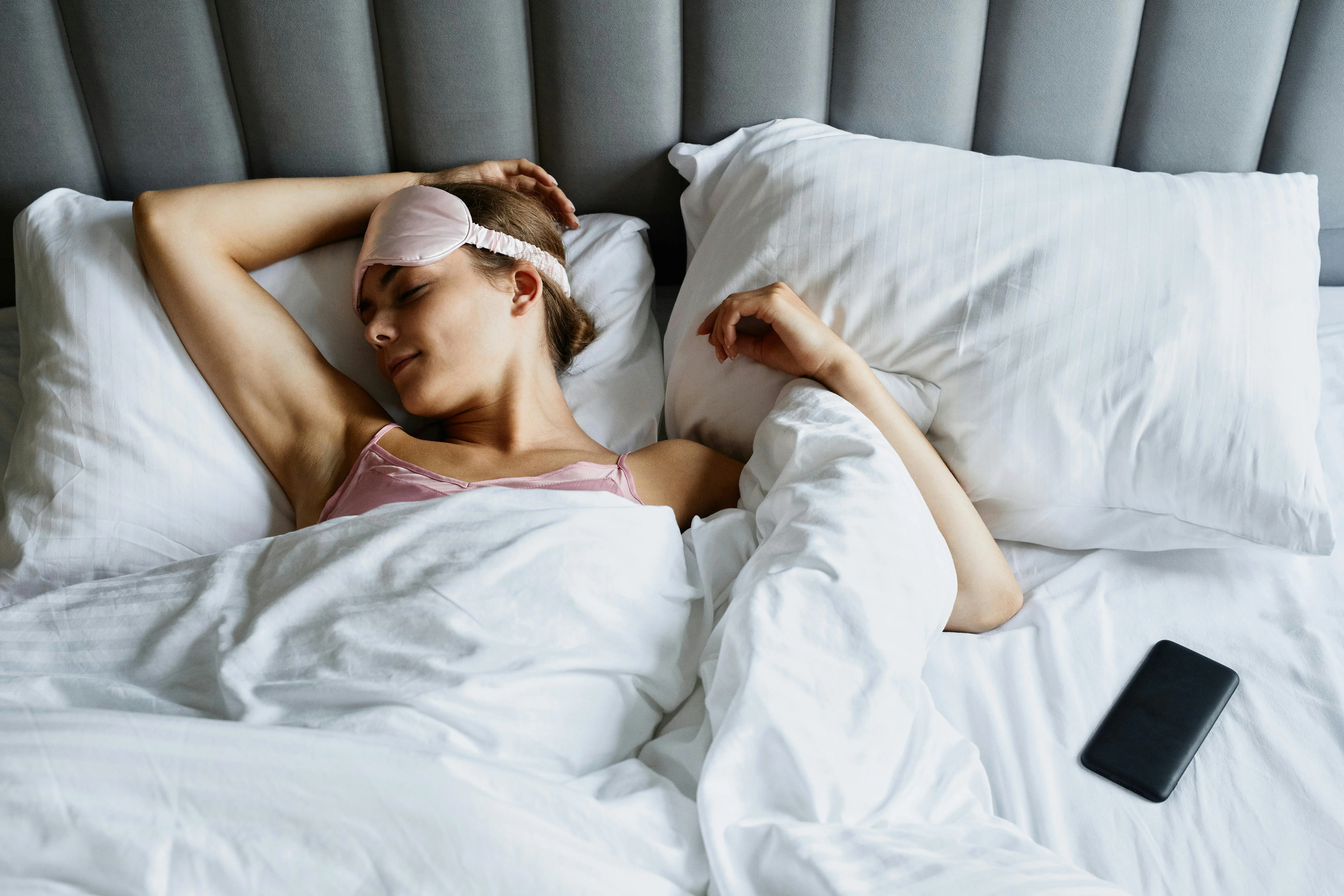 Relaxed woman resting in a clean bedroom, showing how a tidy Richmond Hill home improves sleep and lowers stress.