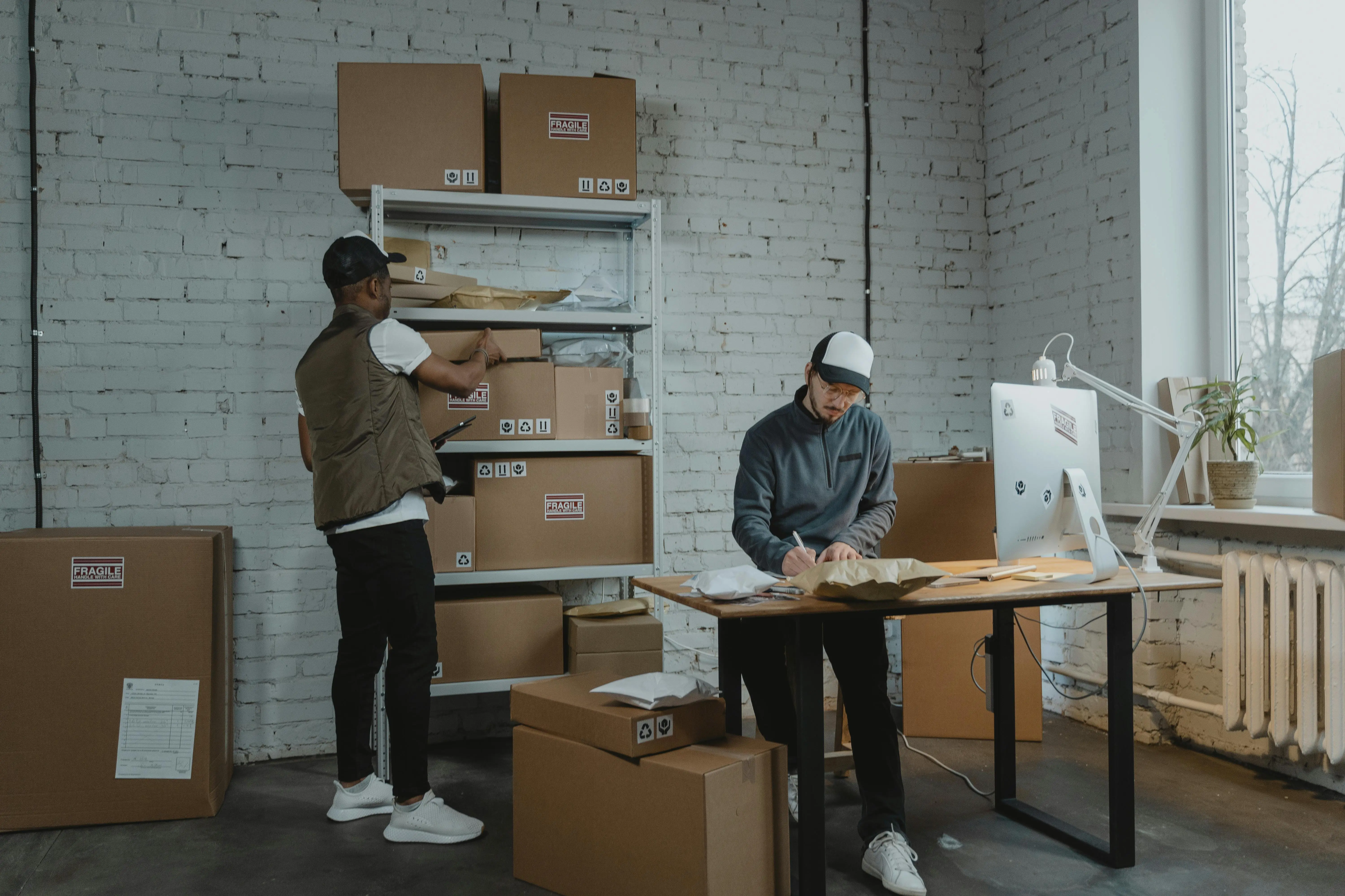 Workers organizing storage boxes in a Markham office, showing how storage solutions support effective workplace cleaning habits.