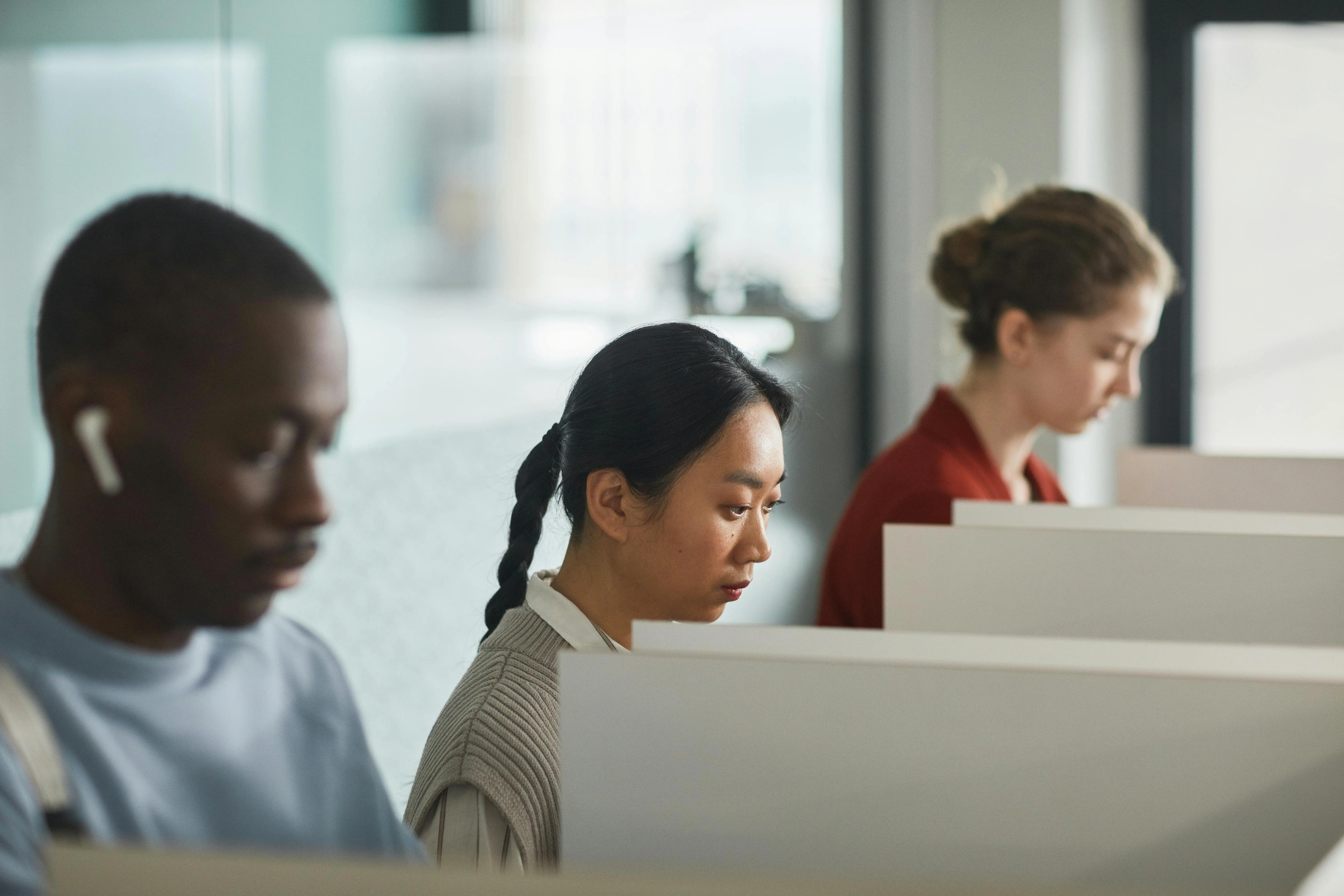 Focused employees working in a clean Markham office space, highlighting the role of daily cleaning habits in boosting productivity.