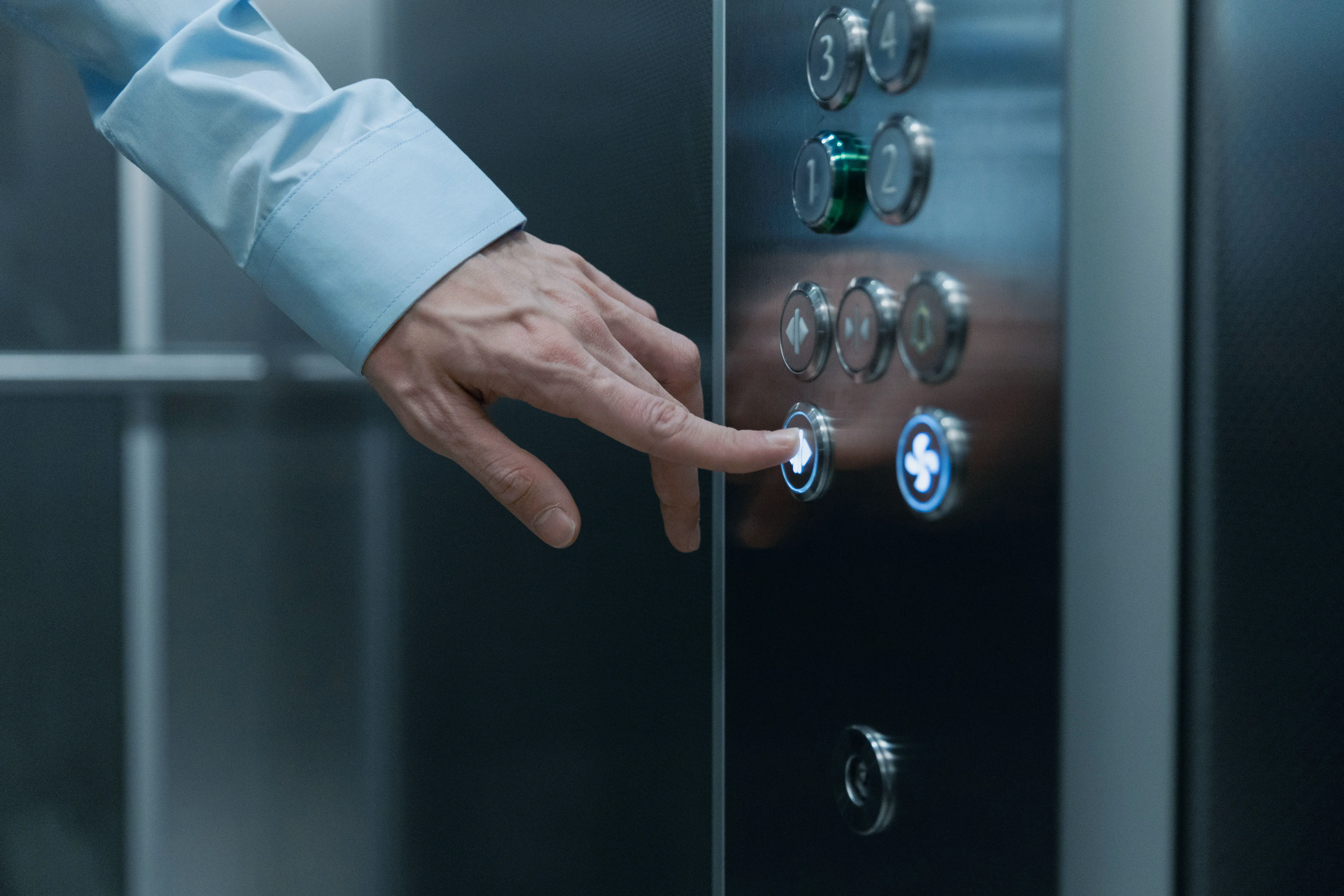 Pressing an elevator button, a key step when booking condo cleaning access