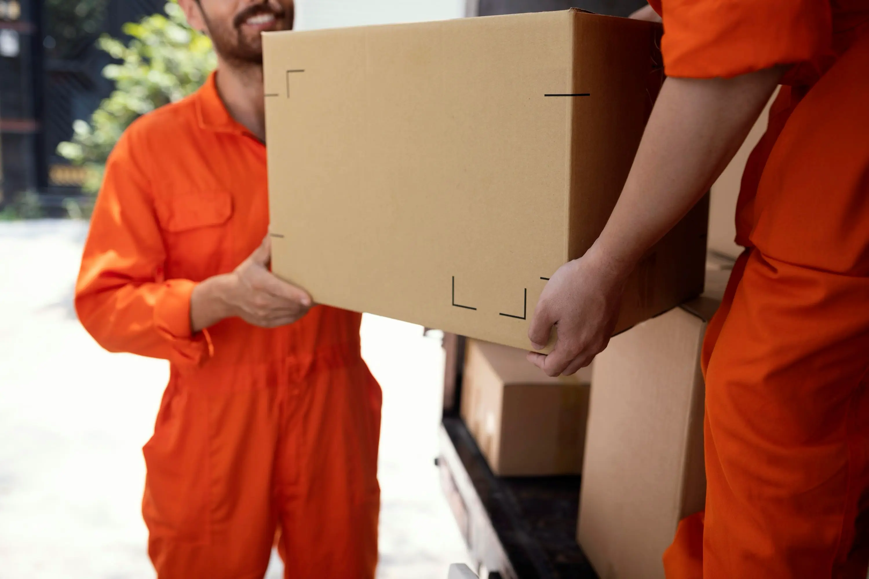 Movers loading boxes on moving day before a move out cleaning