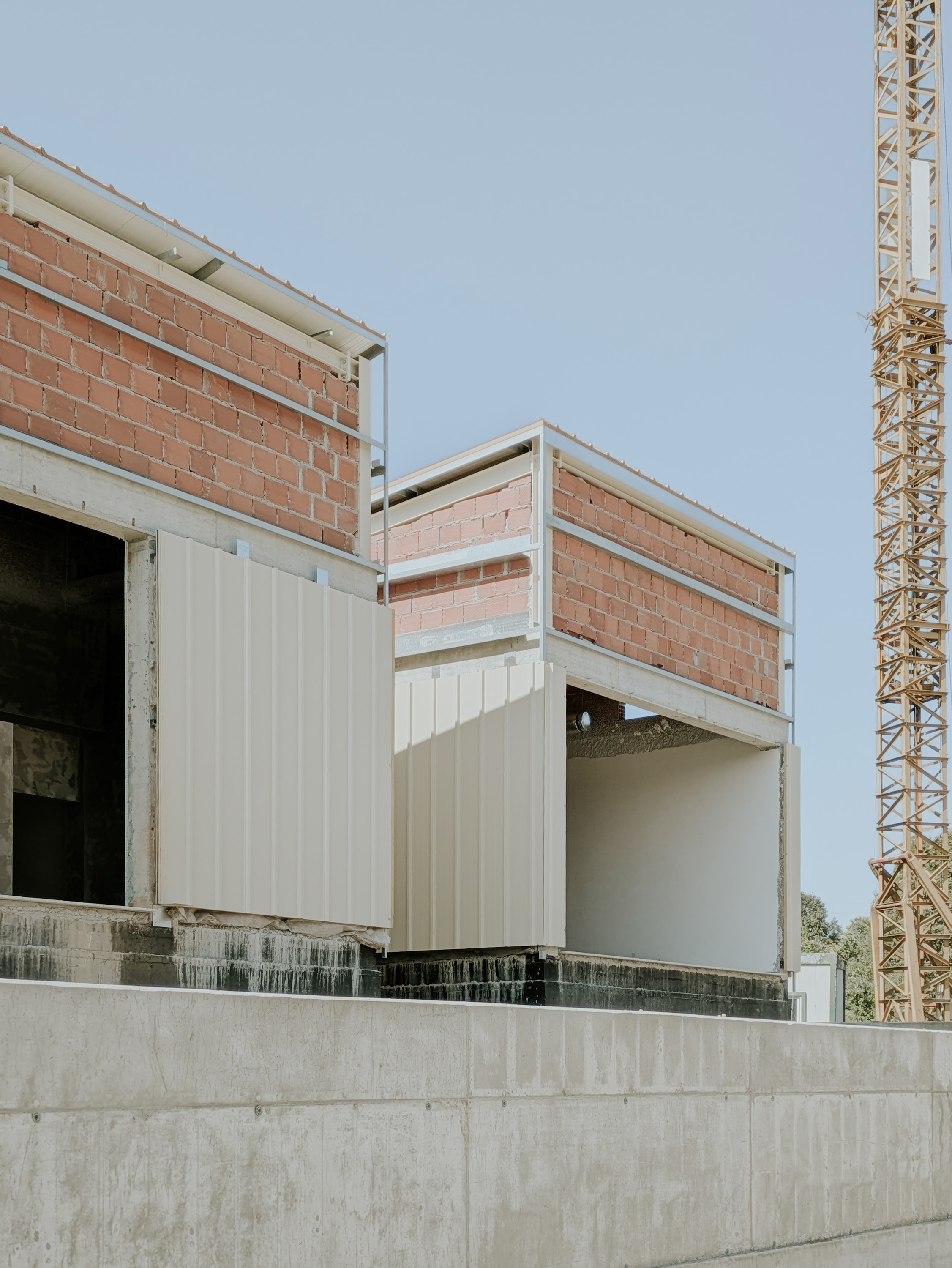A terracotta colour boutique padel center in an industrial warehouse by Salto Studio in Lisbon