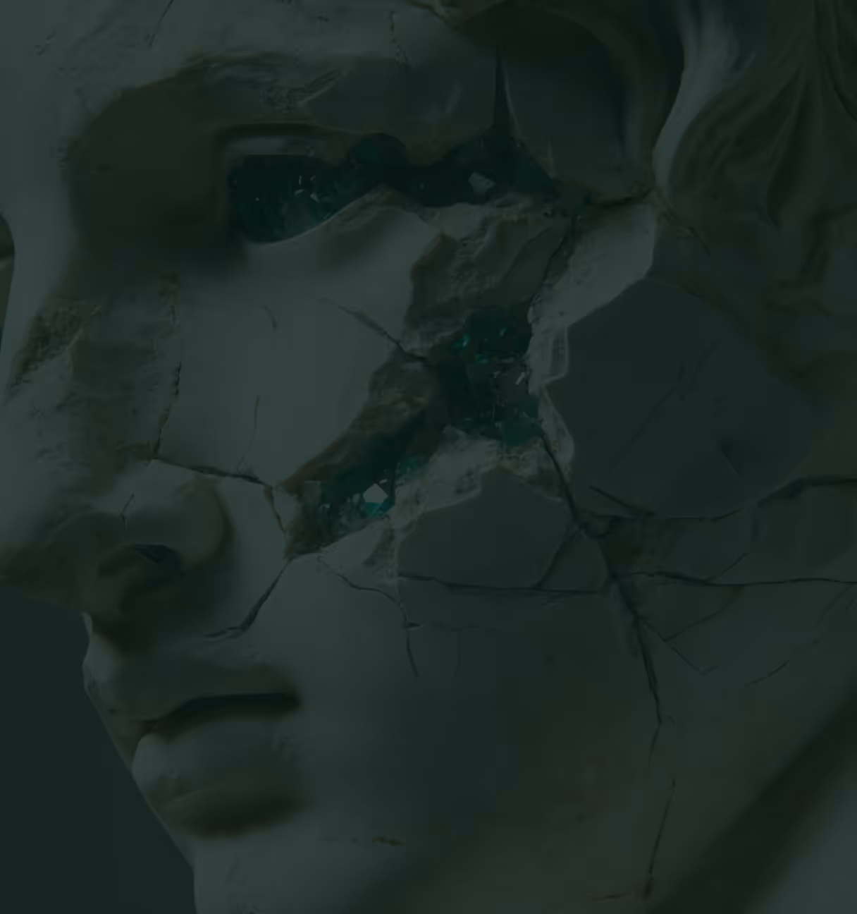 Close-up of a cracked classical stone sculpture head with dark green shards in the eye sockets.