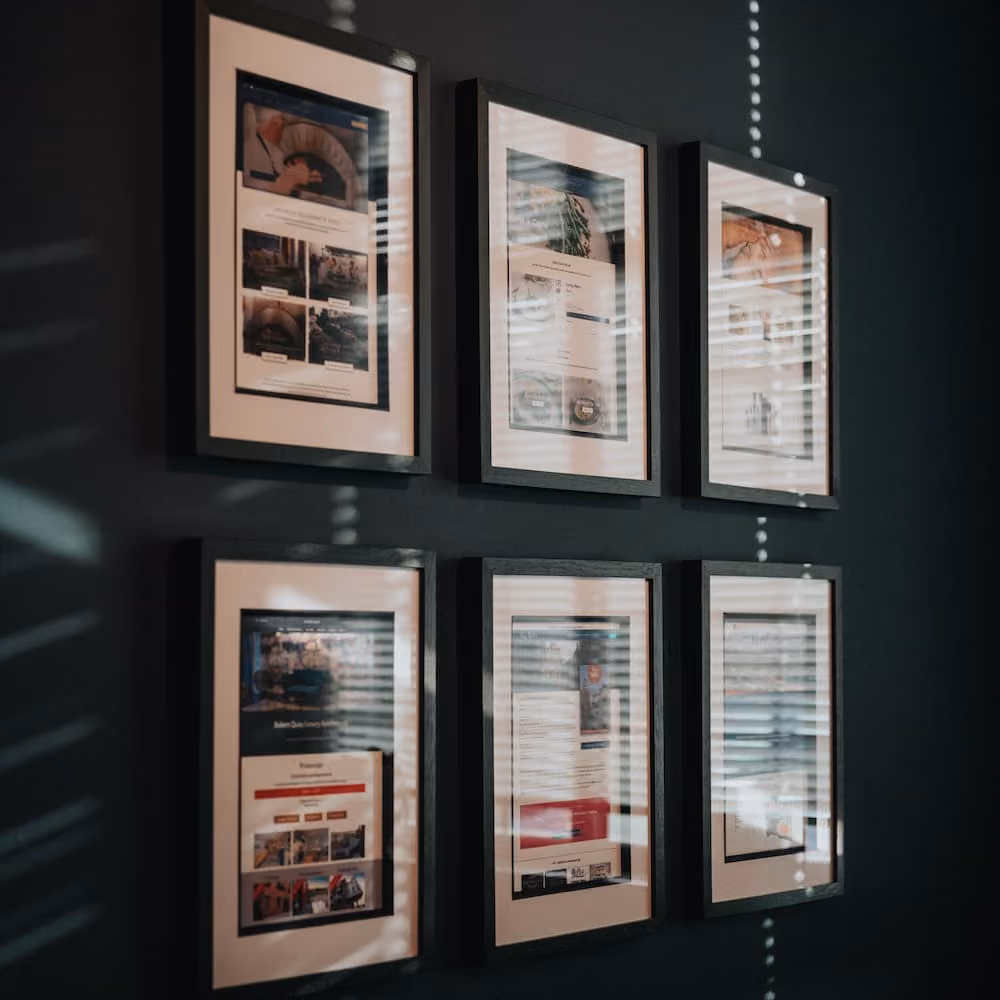 Pictures of websites developed by Webcetera hanging on the wall at our Brigg office.