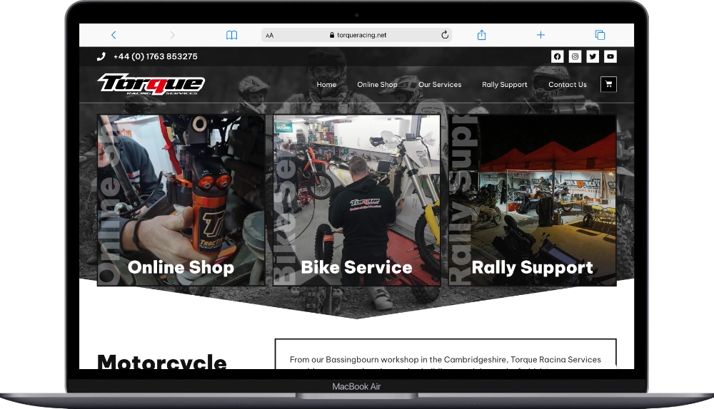 Torque Racing website shown on a laptop screen