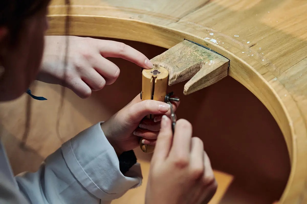 A person working on a jewellery piece in a workshop