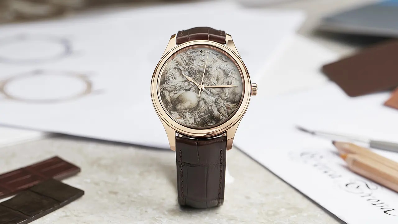 A watch on a table, with sketches in the background