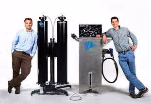 Greg and Matt Roberts of Springboard Biodiesel standing next to biodiesel processors.