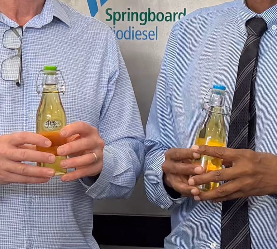 Springboard Biodiesel representatives holding bottles of biodiesel