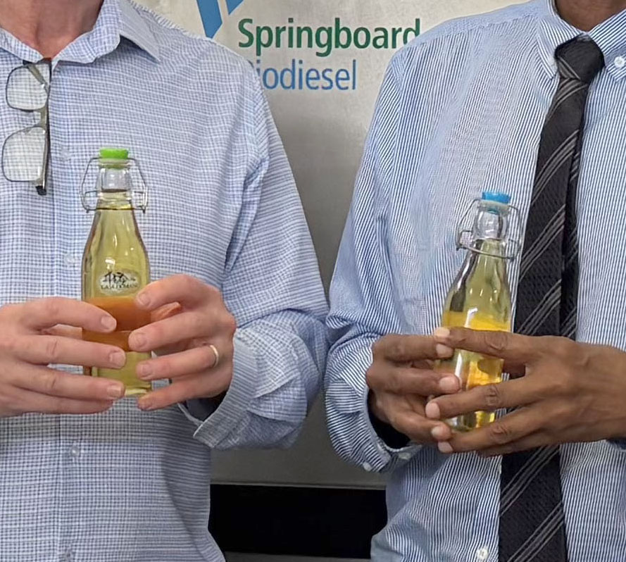 Springboard Biodiesel representatives holding bottles of biodiesel