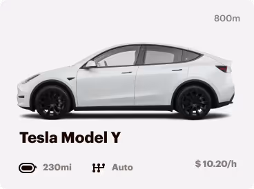 Side view of a white Tesla Model Y electric SUV with 230 miles range and automatic transmission, priced at $10.20 per hour.
