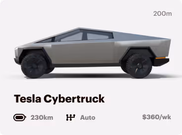 Side view of a silver Tesla Cybertruck with large black wheels, showing a futuristic angular design.