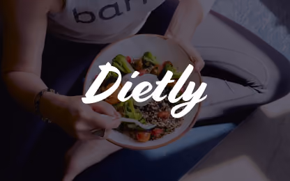 Person holding a bowl of salad with broccoli and cherry tomatoes, the word Dietly overlayed.