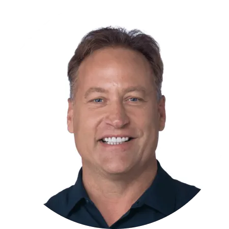 Smiling middle-aged man with short brown hair wearing a dark collared shirt.