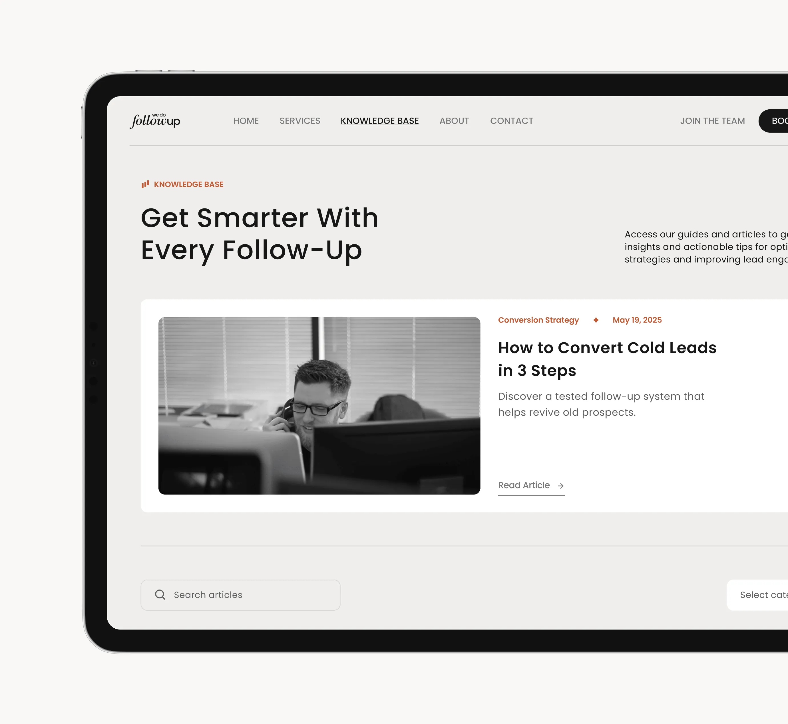 Website knowledge base page titled 'Get Smarter With Every Follow-Up' featuring an article on 'How to Convert Cold Leads in 3 Steps' with a black and white photo of a man wearing glasses talking on the phone behind computer monitors.