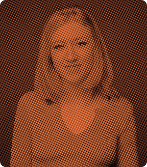 Portrait of a woman with shoulder-length hair wearing a v-neck top, shown with an orange halftone filter.