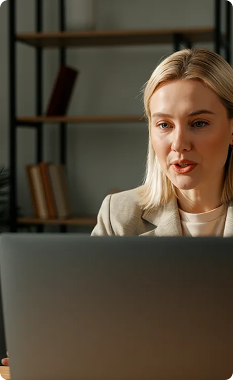 Smiling elderly man with white hair and beard wearing a light blue patterned shirt outdoors.