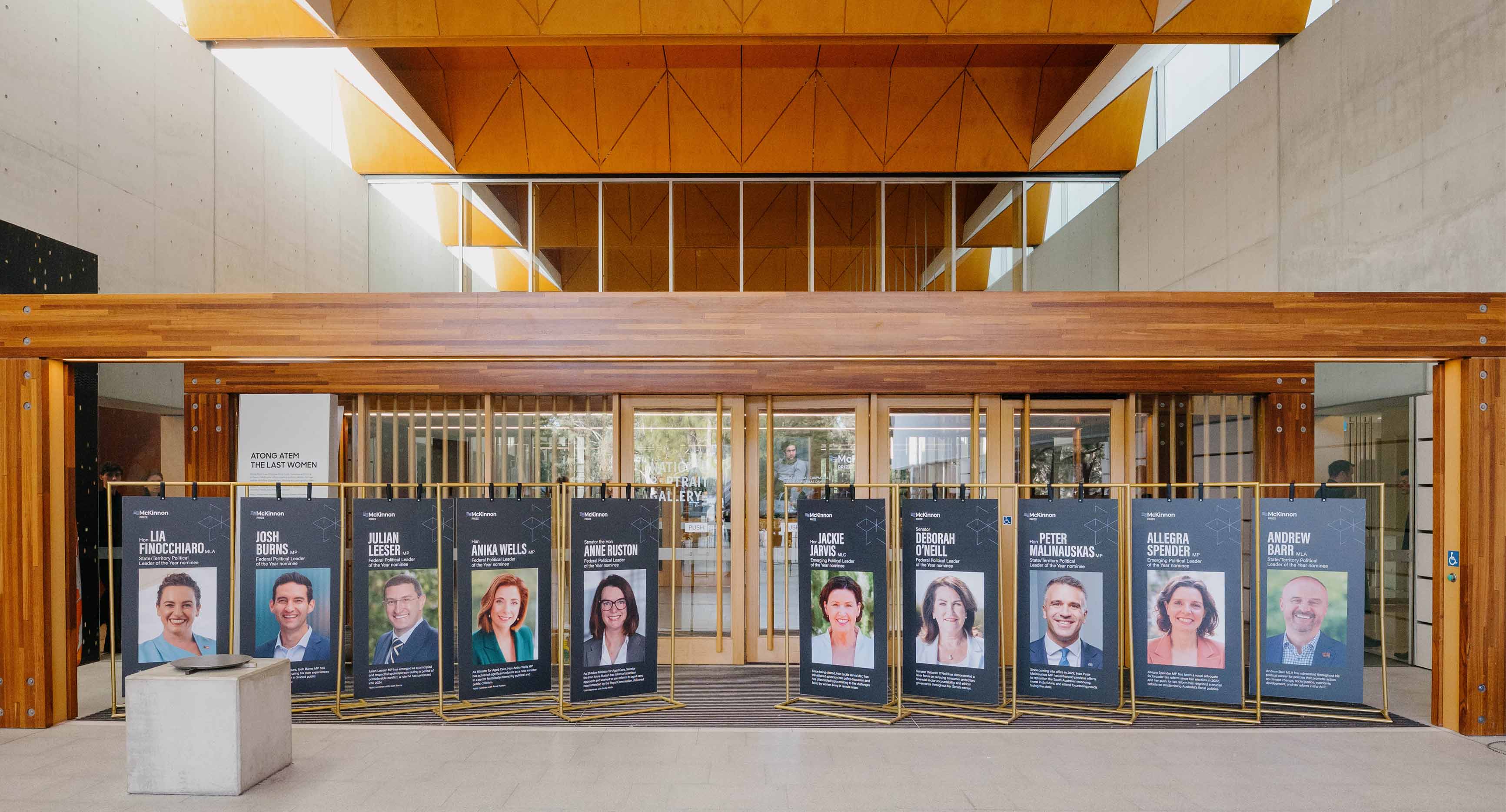 Photo from the McKinnon Prize event 2025. Photo boards of each of the nominees outside the National Portrait Gallery.