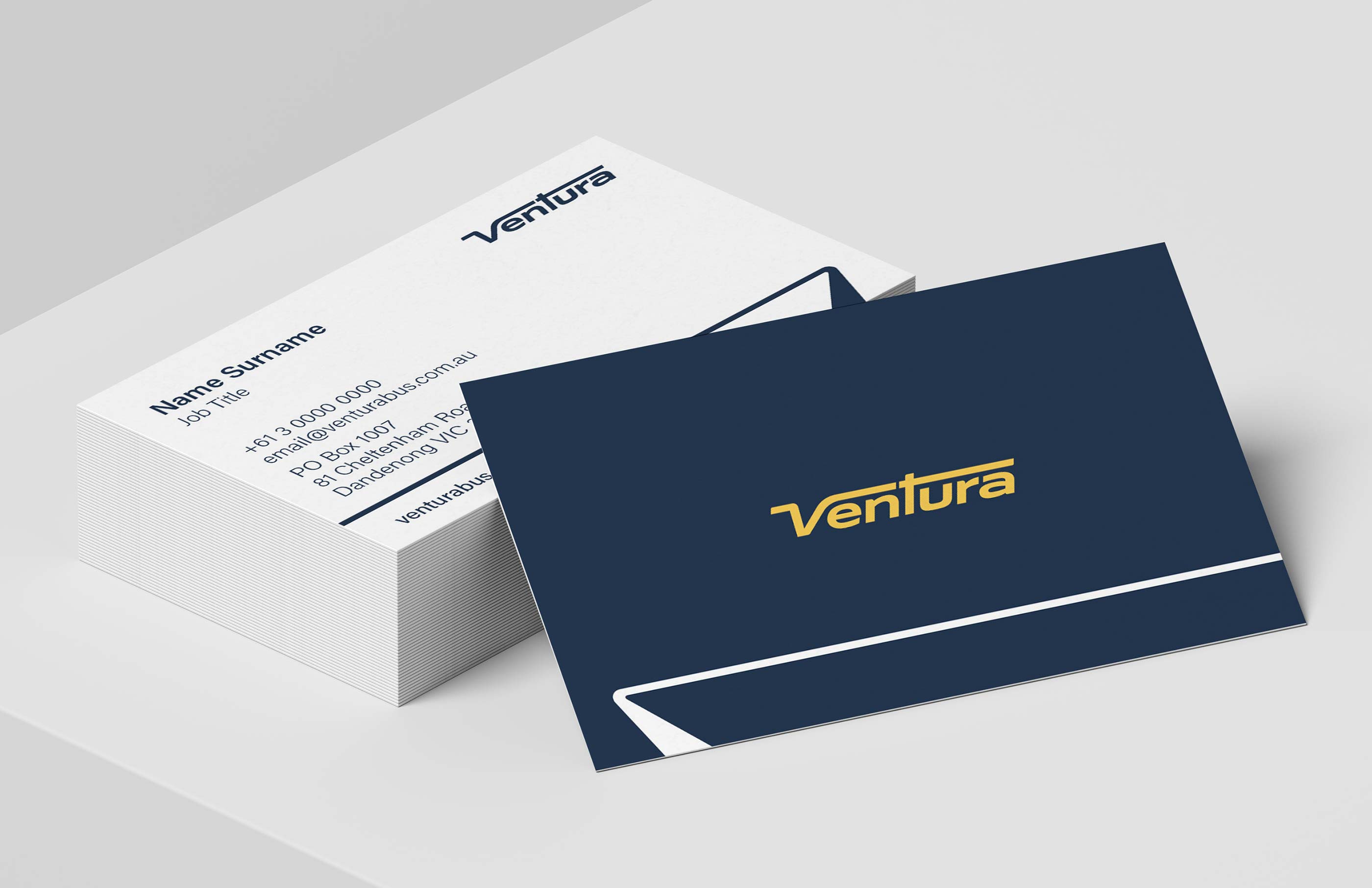 Ventura Bus business card stack, with white back, and navy/yellow front.