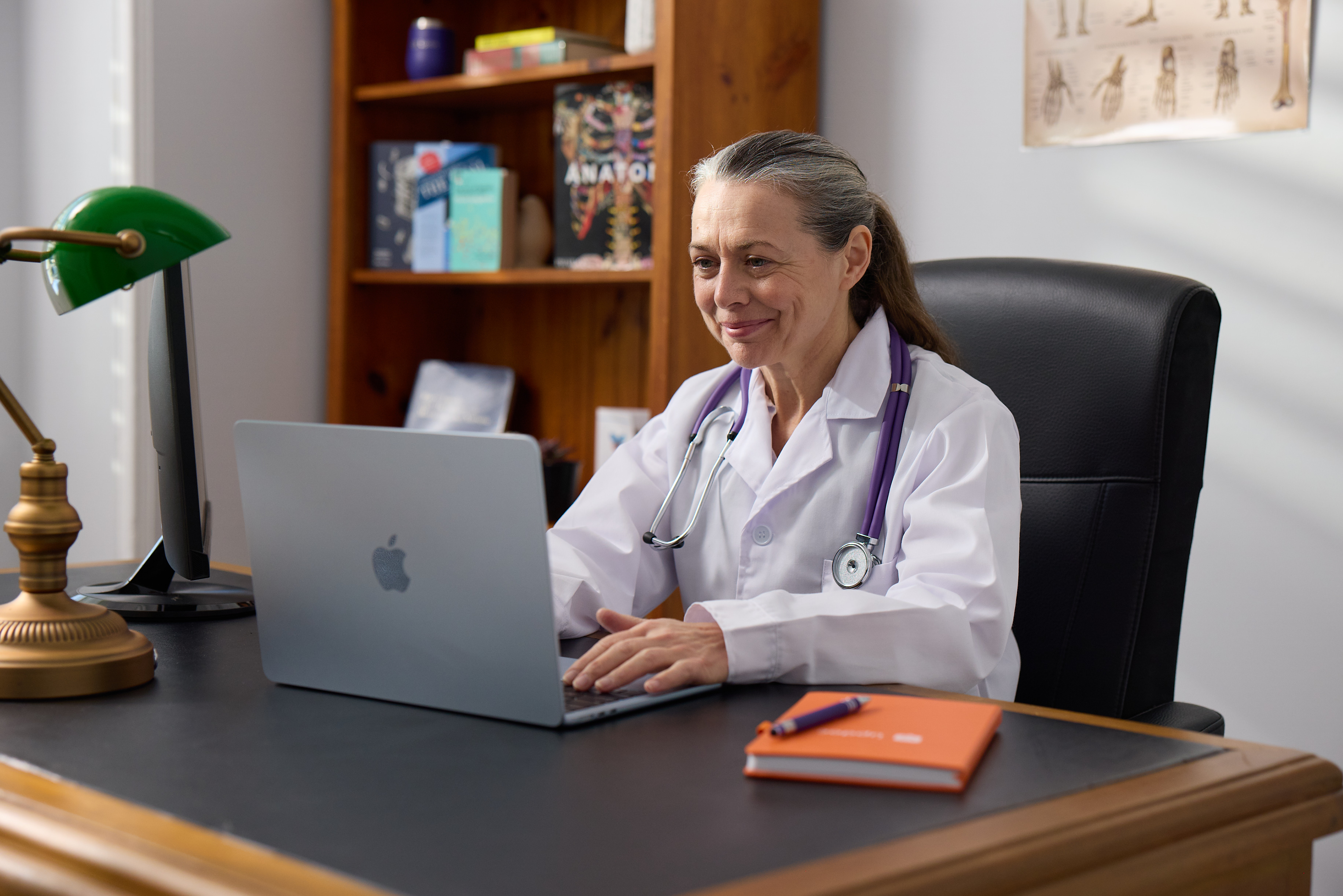 Partner Doctor at a desk reviewing a referral request