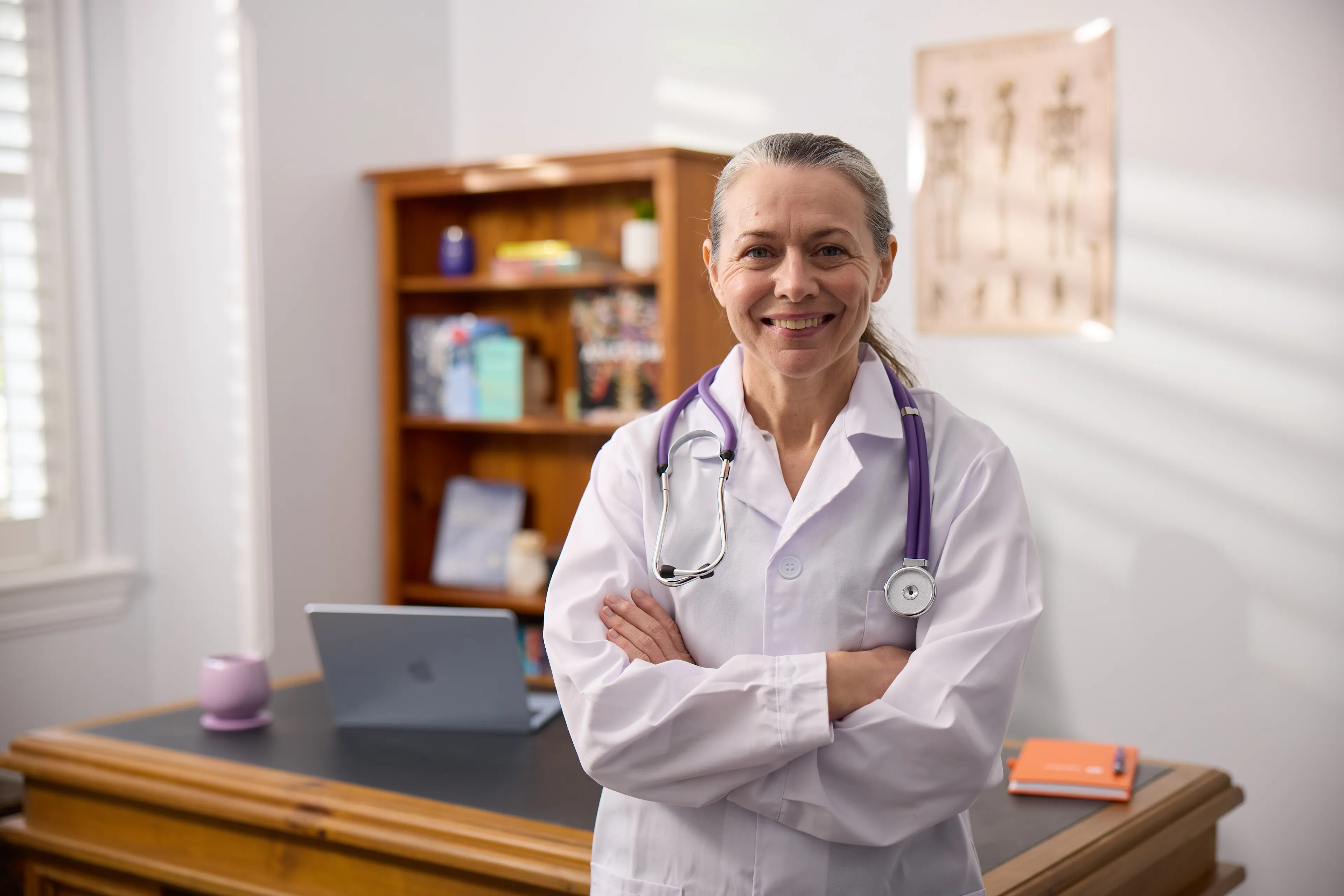 Female Partner Doctor with a stethoscope in her consulting room, ready for ENT specialist referrals