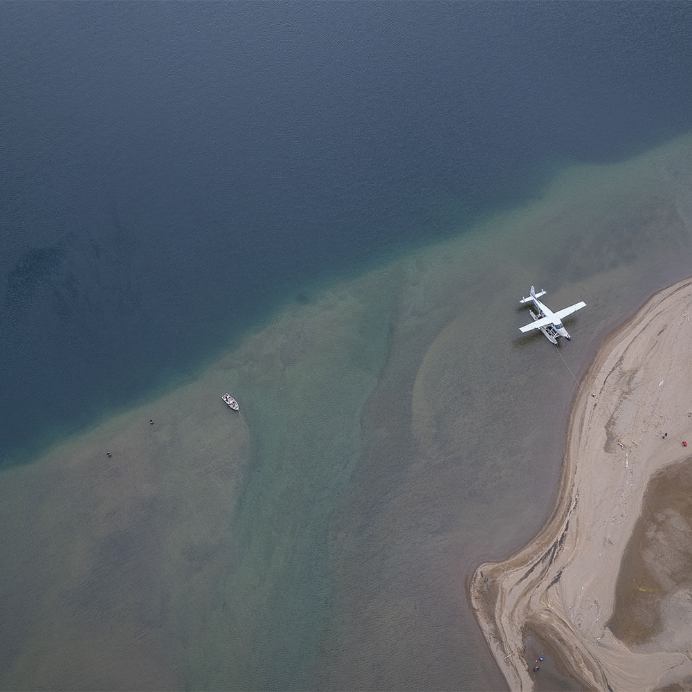 Boats and a float plane parked at Rifflin' Hitch Lodge