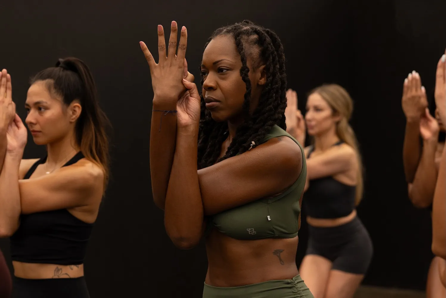 Diverse group of people in workout clothes practicing synchronized movement