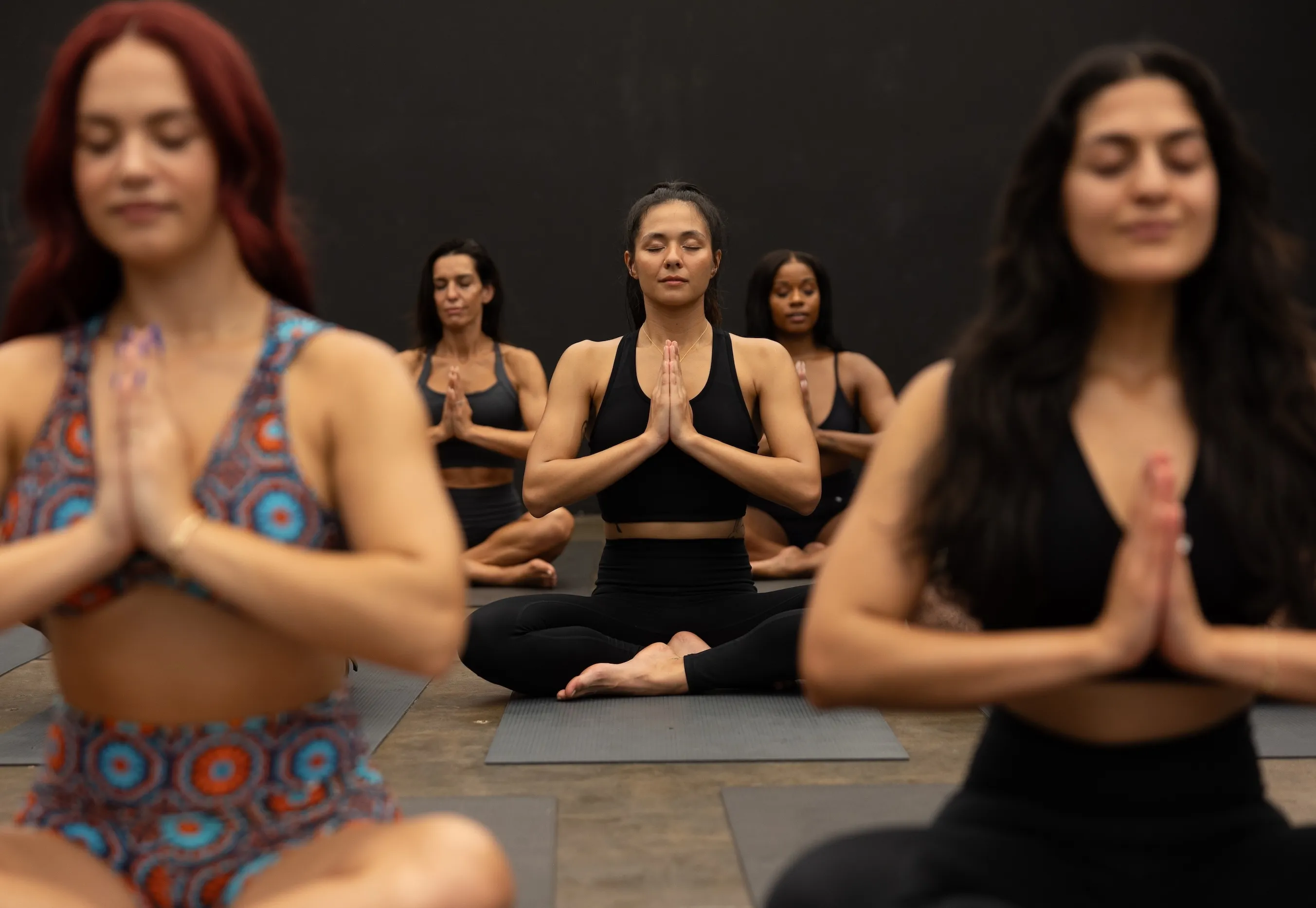 Diverse group of people practicing meditation and yoga together