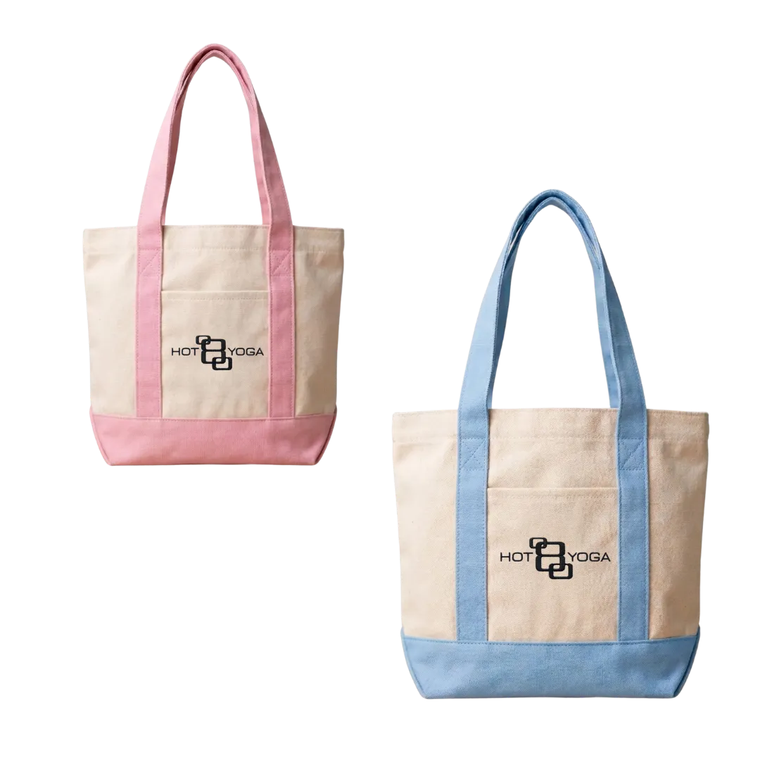 Two canvas tote bags with colored handles, one pink and one blue, featuring Hot 8 Yoga logo