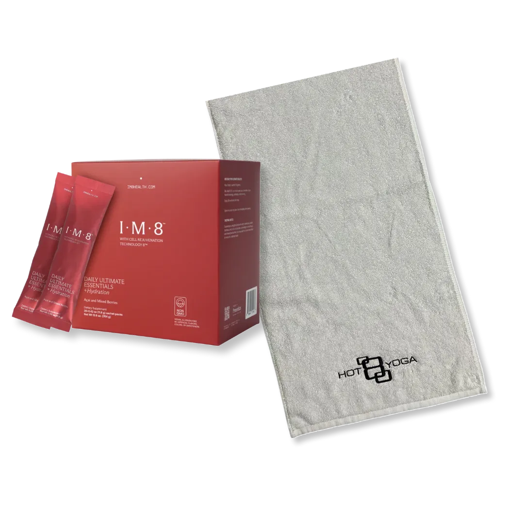Red IM8 skincare product box with sachets and gray yoga towel on white background.