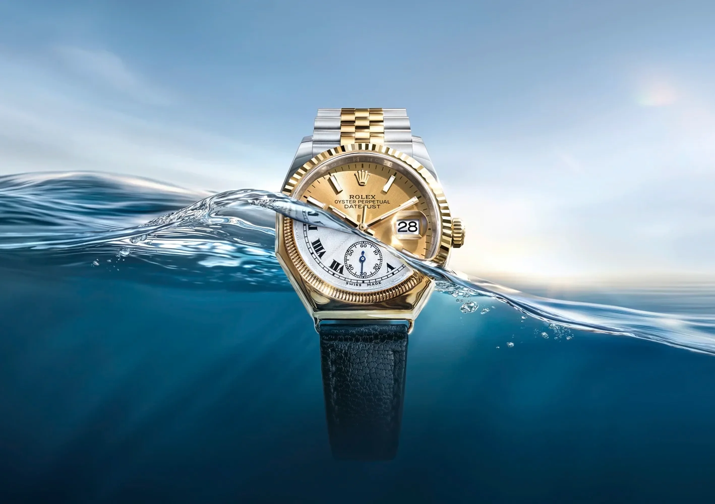 A Rolex watch partially submerged with water splashing mid-face under a clear sky.
