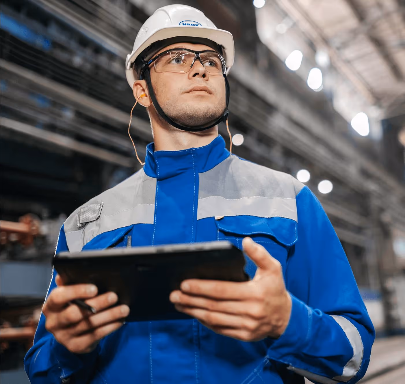 Factory manager reviewing production data on a tablet