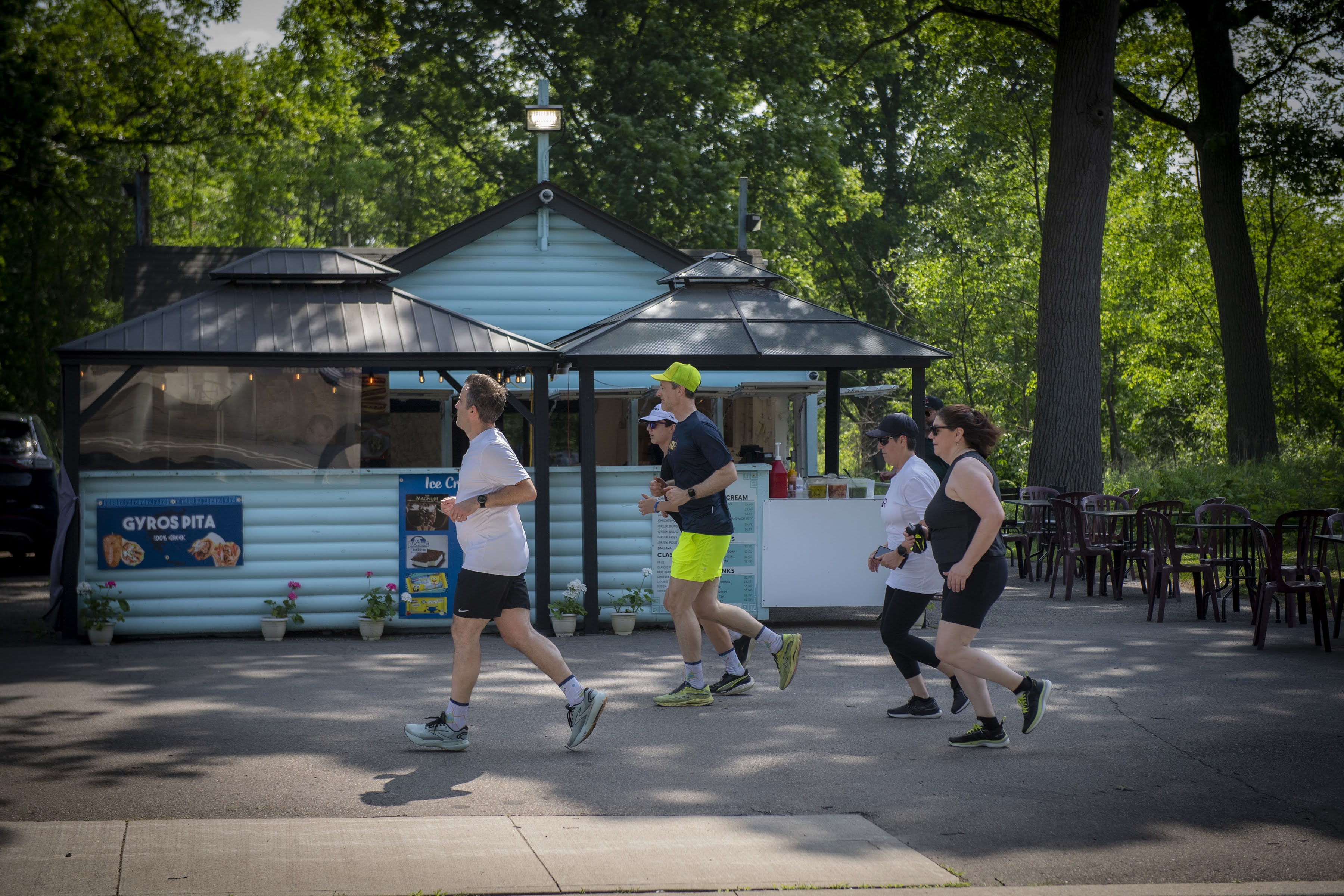 A None to Run group running together through a park on a sunny morning