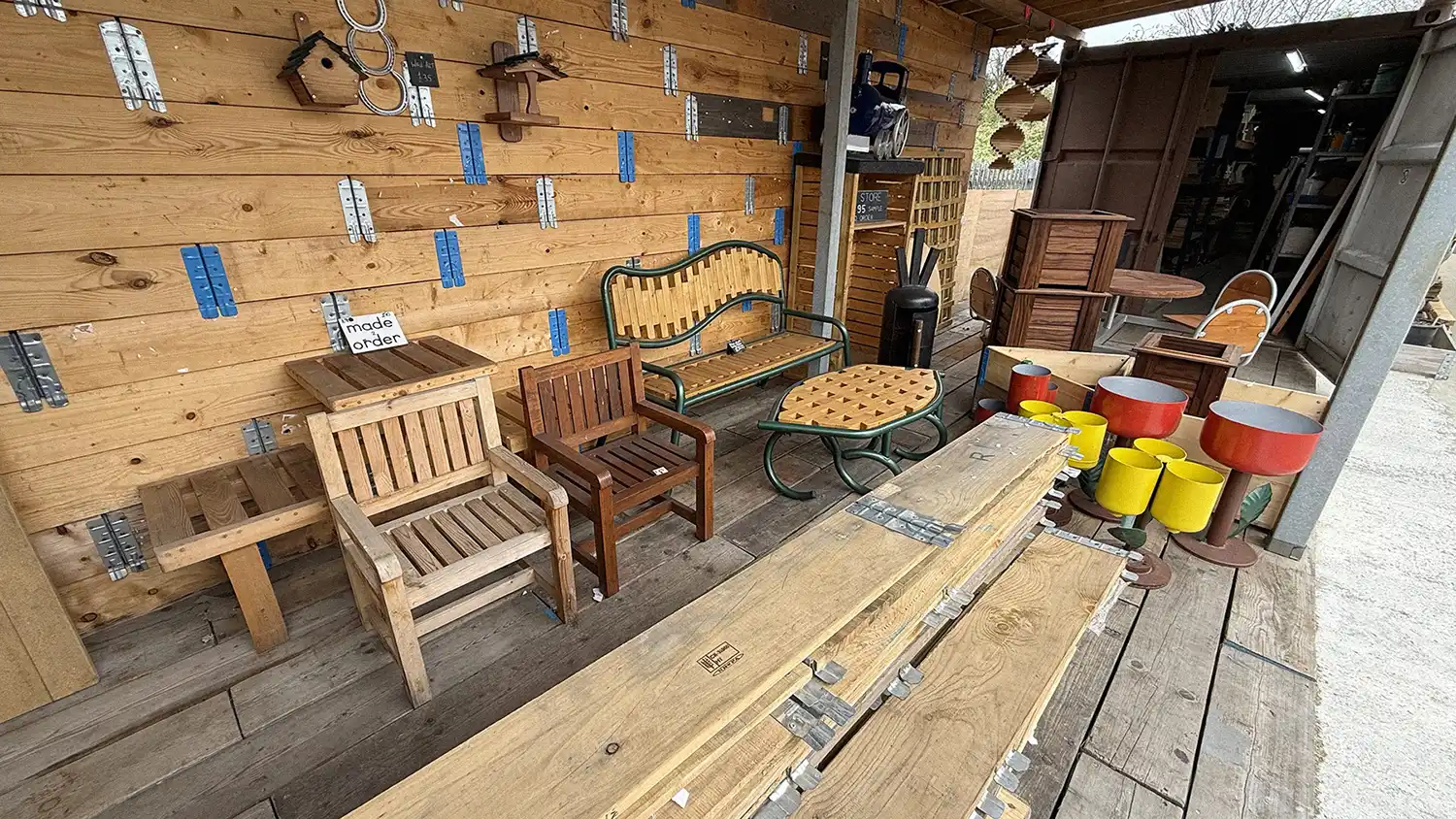 The external part of the Turning Corners Factory Workshop in Hull, showing a myriad of recycled metal and wooden attendee made items for sale.