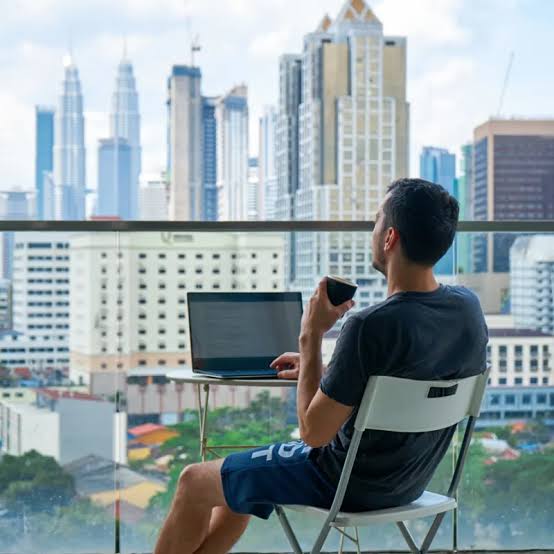 Image of a digital nomad working from home with a view of a city