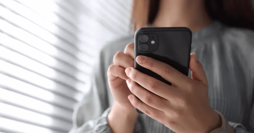 a person holding a pink phone