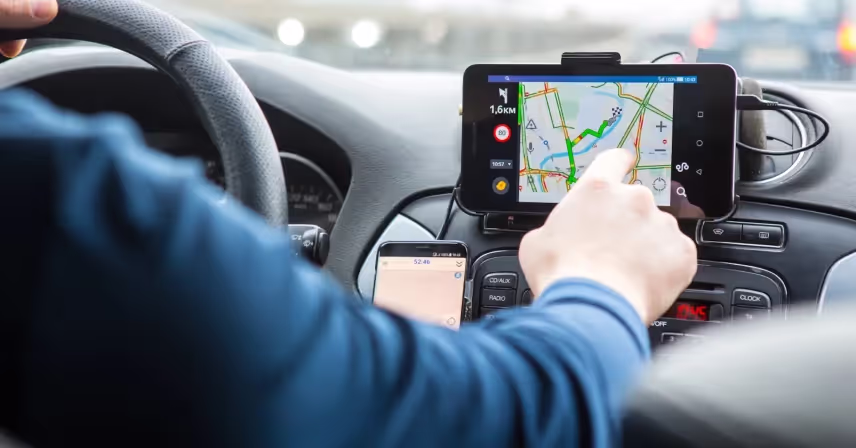 a person using a gps device in a car