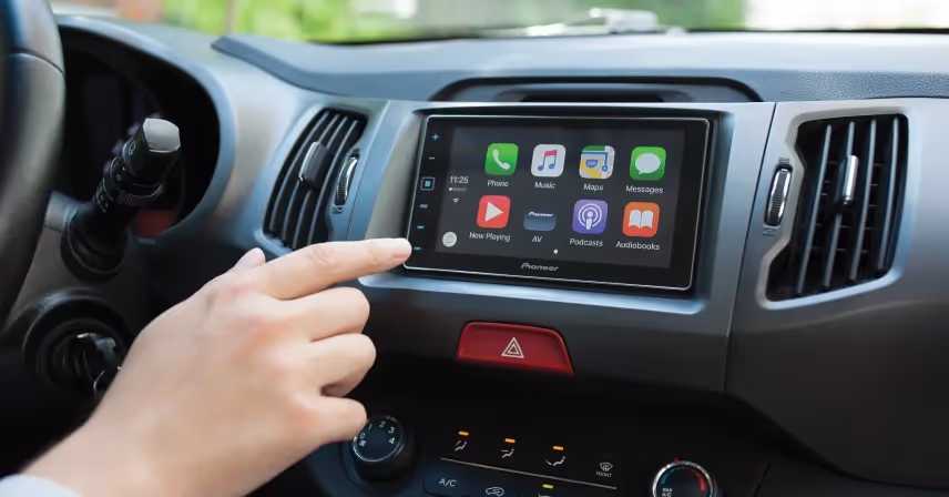 a person touching a touch screen in a car