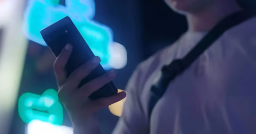 a hand holding a cell phone