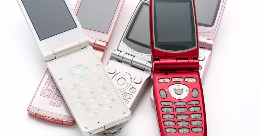collection of various open flip phones in different colors arranged on a white background