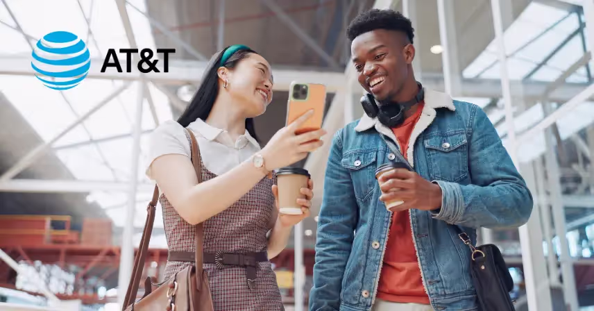 Couple using cell phones while walking through airport
