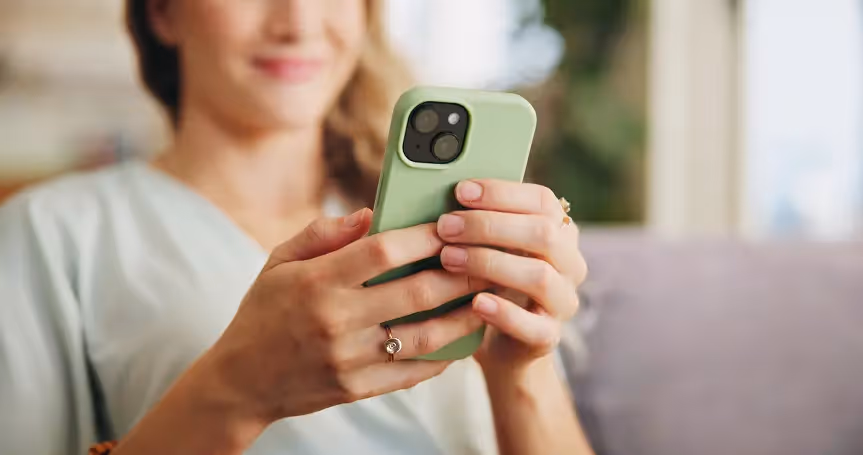 Woman holding Mint Mobile phone.