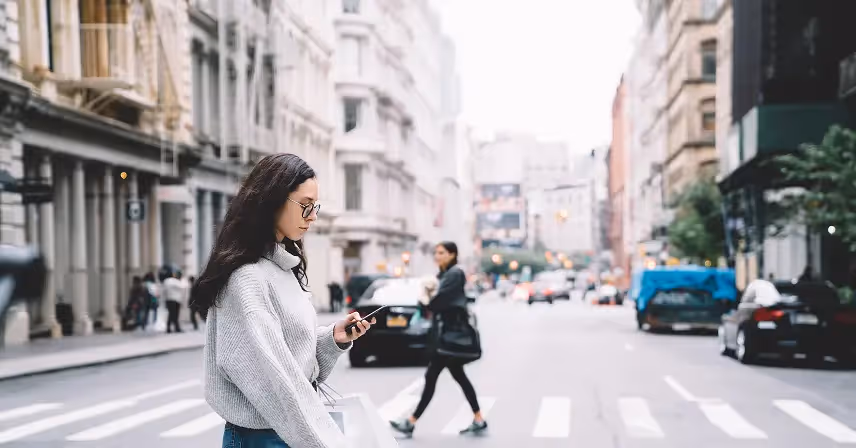 a woman looking at phone with cell phone plan carrier