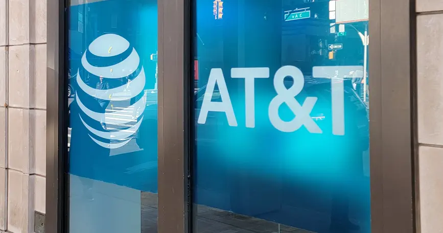 The image shows the exterior signage of AT&T, featuring its logo and company name.
