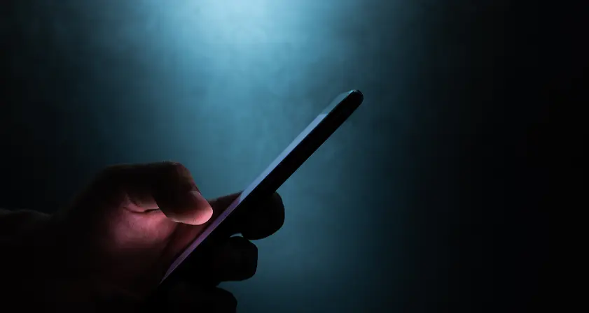 a phone with a security image on the screen laying flat on a table