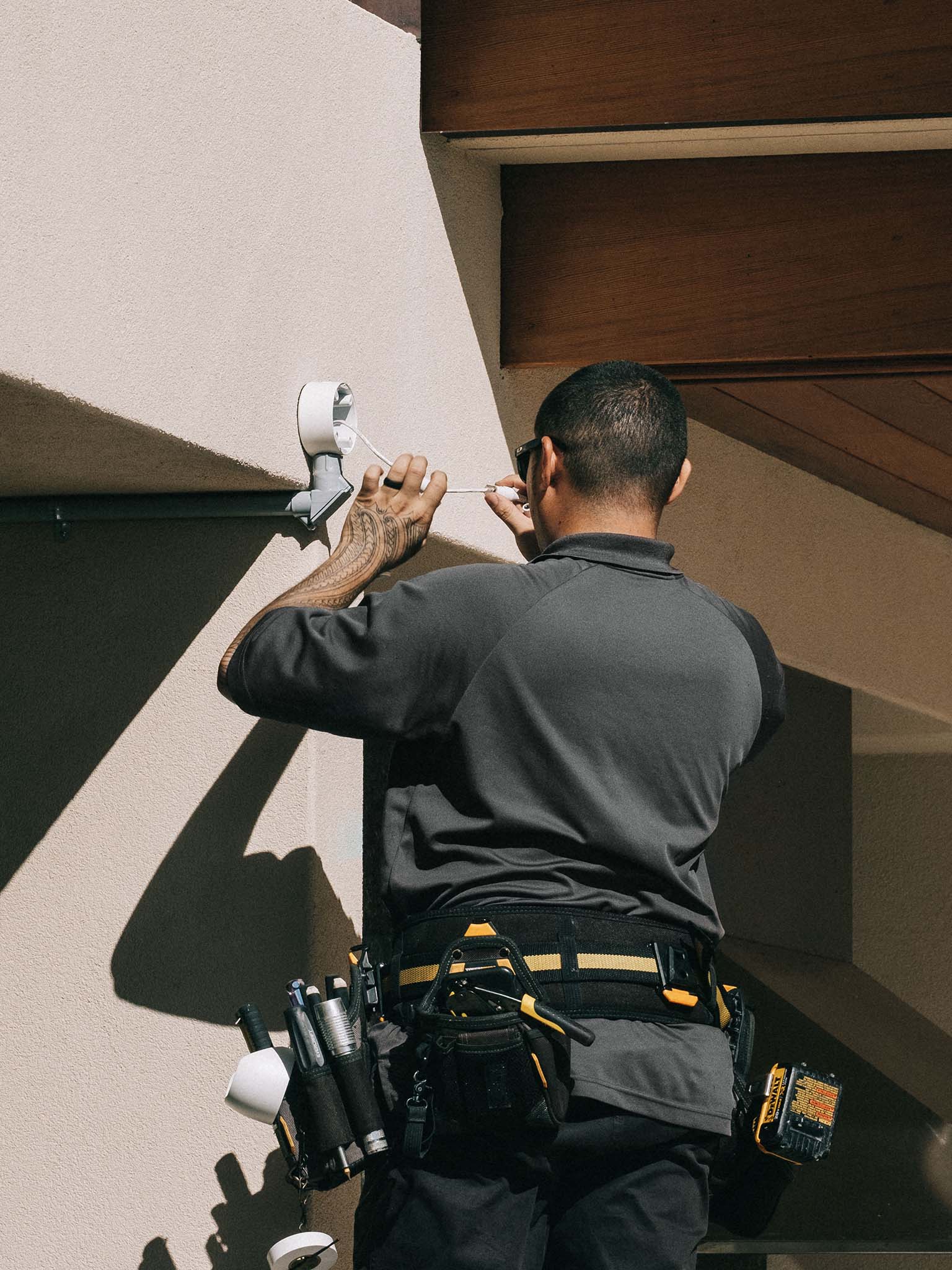 Cam Security Employee installing a security camera on a wall