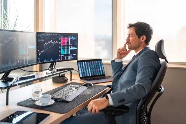Options trader analyzing multiple screens